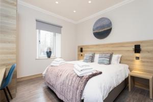 a bedroom with a large bed with a wooden headboard at The Barclay Apartment in Perth