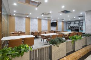 a conference room with tables and chairs and a tv at Hummer Hotel & Apartment Da Nang Beach in Da Nang