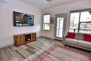 a living room with a couch and a tv at The Highland Hangout by Casago McCall - Donerightmanagement in McCall