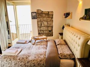 a bedroom with a bed with a table on it at Cà Milla Argegno apartment in Argegno