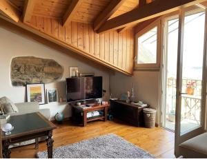 a living room with a couch and a table at Cà Milla Argegno apartment in Argegno