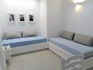 A bed or beds in a room at Drouga's Studios & Suites Astypalaia Greece