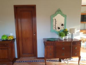 a room with a dresser and a mirror on a wall at Big Fish 1 - Charming Beach Apartment in Praia de Mira