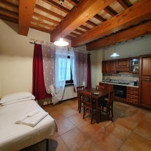 una camera con letto e tavolo e una cucina di Pietra Maula Agriturismo a Castelraimondo