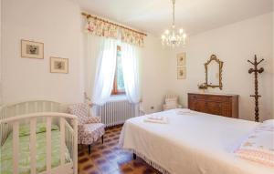 a bedroom with a bed and a chair and a mirror at Casa Ciricea in Piteccio