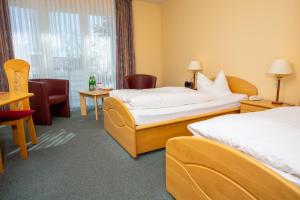 Postel nebo postele na pokoji v ubytování Hotel Heikenberg