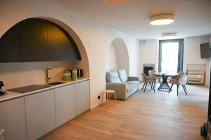 a kitchen and living room with a couch and a table at La casa di Alice in Monopoli