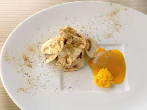 a white plate topped with food on a table at Mercure Yokosuka in Yokosuka