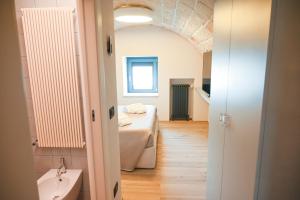 a bathroom with a bed and a sink in a room at La casa di Alice in Monopoli +62 photos