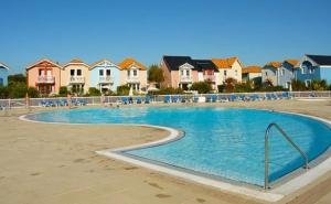 a swimming pool in a residential neighborhood with houses at Le Bosquito - Piscine Avril a Septembre in Saint-Hilaire-de-Talmont