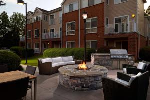 a patio with a fire pit in front of a building at Sonesta ES Suites Atlanta Alpharetta Windward in Alpharetta