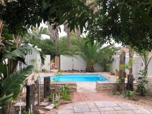 a swimming pool in a yard with trees at Old Cape on the Marina - De Pond : Unit 6 in Velddrif