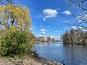 a view of a lake with a building in the background at Luxury 60m2 Appartement in Wilhelmstadt Berlin in Berlin