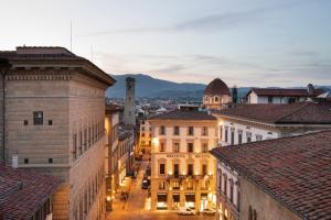 a view of a city at night with buildings at Helvetia&Bristol Firenze – Starhotels Collezione in Florence