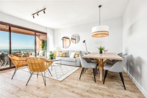 iloftmalaga SkyGarden في مالقة: غرفة طعام وغرفة معيشة مع طاولة وكراسي