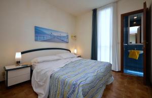 En eller flere senge i et værelse på Appartamenti Oasi