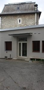 un gran edificio blanco con una gran ventana en él en Joli Studio Chamechaude, en Saint-Pierre-de-Chartreuse