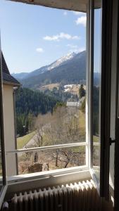 a window with a view of a snow covered mountain at Joli Studio Chamechaude in Saint-Pierre-de-Chartreuse