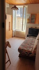 1 dormitorio con cama y ventana grande en Joli Studio Chamechaude, en Saint-Pierre-de-Chartreuse