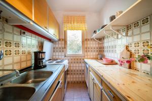 a kitchen with a sink and a counter top at Fia 70s Beach Apartment in Rab +19 photos