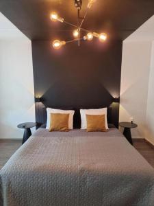 a bedroom with a large bed with two tables at Marianna - studio for two in Groningen +1 photo
