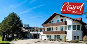 a building with a cocacola sign on the side of it at Landhotel Tanneneck - ideal für Gruppen, Familien und Hunde in Löffingen
