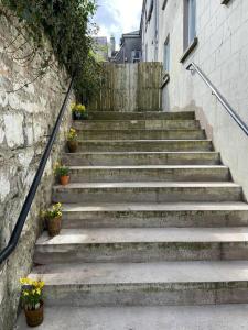 eine Treppe neben einem Gebäude mit Blumen in der Unterkunft Town house in ideal location central Enniskillen in Enniskillen