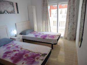 dwa łóżka w pokoju z oknem w obiekcie Seychelles Two Bedroom Apartment RP043 w mieście La Manga del Mar Menor +9 zdjęć
