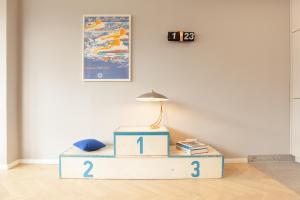 a table with a lamp on top of it at OSTKÜSTE - Kaiser Karl Design Apartments in Heringsdorf