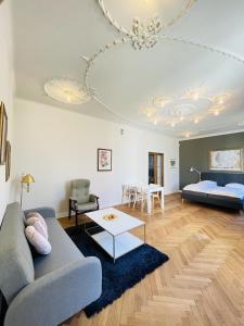 a living room with a couch and a table at aday - Frederikshavn City Center - Luxurious room in Frederikshavn