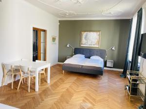 a bedroom with a bed and a table and chairs at aday - Frederikshavn City Center - Luxurious room in Frederikshavn