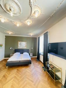 a bedroom with a bed and a chandelier at aday - Frederikshavn City Center - Luxurious room in Frederikshavn