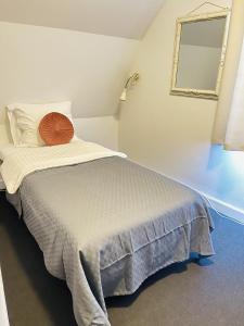 a bedroom with a bed with a mirror on the wall at aday - Frederikshavn City Center - Single room in Frederikshavn