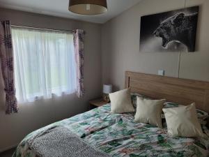 a bedroom with a bed with pillows and a window at Remarkable 3-Bed House in Hull in Hull