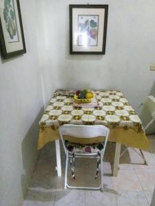a table with a bowl of fruit and a chair at Remarkable 2-Bed Villa in Fair Prospect Sea View in Port Antonio