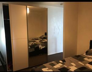 a bedroom with a large wardrobe and a bed at Immaculate 1-Bed Apartment in Stoke-on-Trent in Stoke on Trent