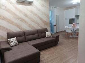 a living room with a brown couch and a table at Casa Micaela in Chioggia +23 photos
