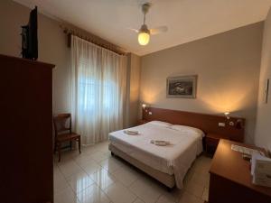Ένα ή περισσότερα κρεβάτια σε δωμάτιο στο Hotel Adriatico