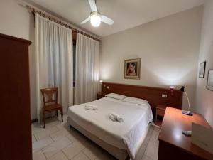 Ένα ή περισσότερα κρεβάτια σε δωμάτιο στο Hotel Adriatico
