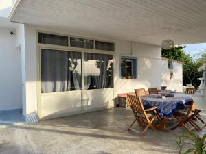 a patio with a table and chairs on a house at Villa Priscilla in Cinisi