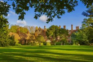 a large house with a green lawn in front of it at Elizabethan Manor House - Sleeps 2-4 - Parking in Burnham-on-Crouch