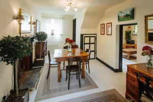 a living room with a wooden table and chairs at Breathtaking Elizabethan Manor House in Burnham-on-Crouch