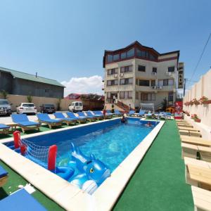 a swimming pool with a inflatable dolphin in the middle at Felix Residence Costinesti in Costinesti