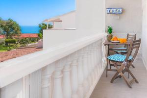 a balcony with a table and chairs and the ocean at Bungalow Blue Dream 4 - Sea views, terrace and pool in Gran Alacant