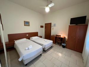 Ένα ή περισσότερα κρεβάτια σε δωμάτιο στο Hotel Adriatico