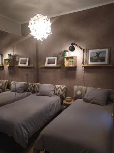 1 dormitorio con 2 camas y lámpara de araña en bilbao center apt 90´s PARKING, en Bilbao