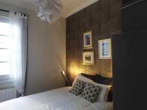 1 dormitorio con cama blanca y ventana en bilbao center apt 90´s PARKING, en Bilbao