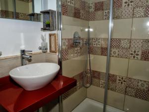 a bathroom with a sink, mirror, and bathtub at Le Cupole Decò in Palermo