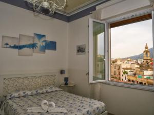 a bedroom with a bed and a large window at Le Cupole Decò in Palermo