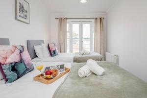 Habitación de hotel con 2 camas y bandeja de comida en Bright and cozy 2-Bed Apartment in Dagenham, en Dagenham